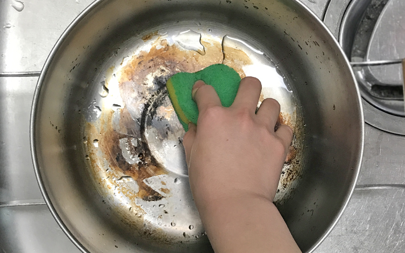 クエン酸でつけ置きした鍋を洗う